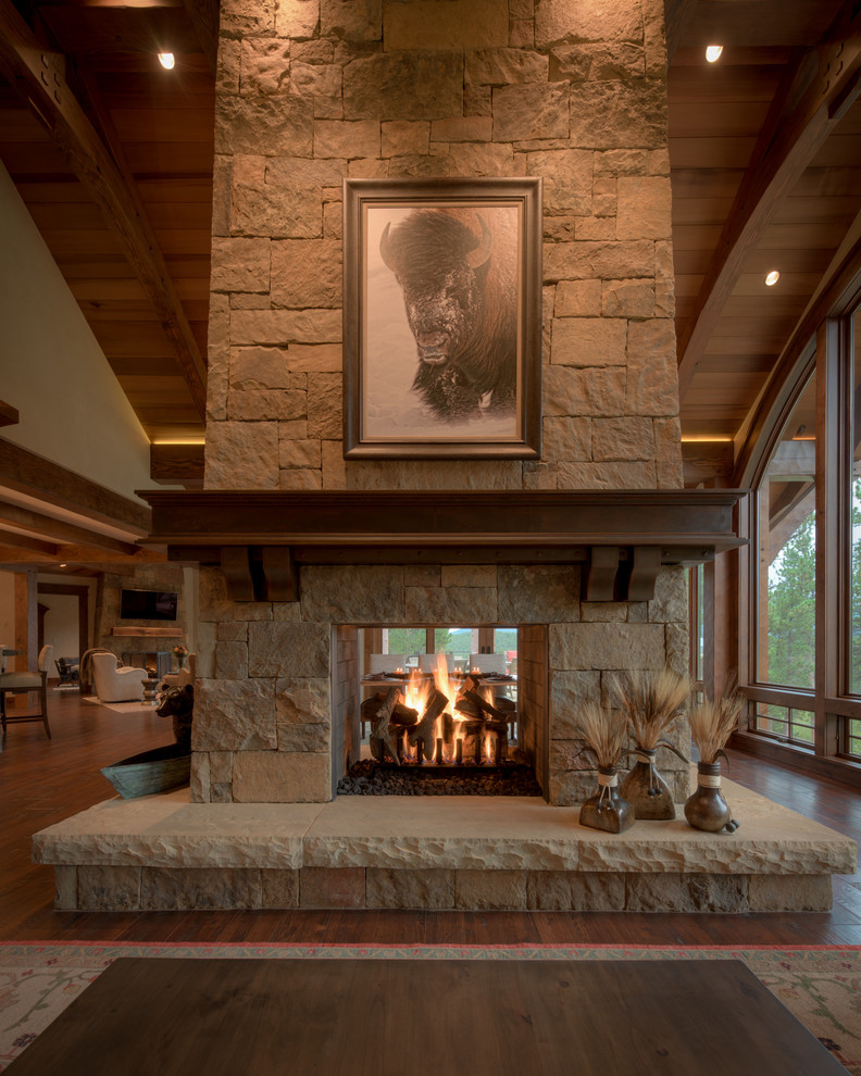 Design ideas for a country open concept living room in Denver with a two-sided fireplace and a stone fireplace surround.