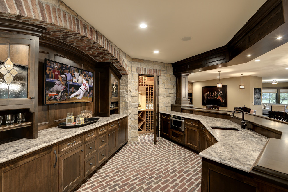 Design ideas for an expansive traditional galley seated home bar in Minneapolis with brick floors, an undermount sink, recessed-panel cabinets, dark wood cabinets and red floor.
