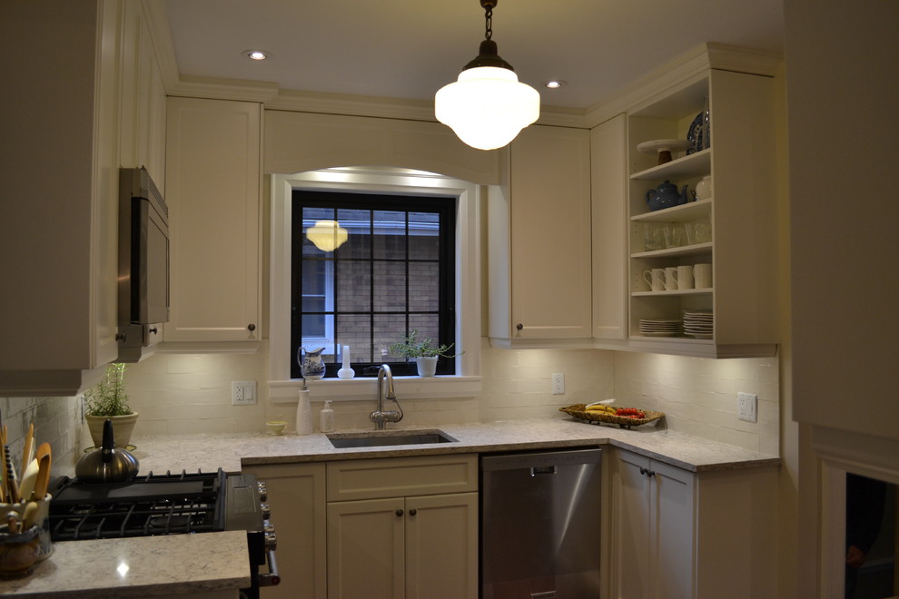 Enclosed kitchen - small transitional galley medium tone wood floor enclosed kitchen idea in Toronto with an undermount sink, quartzite countertops, white backsplash, porcelain backsplash, stainless steel appliances, no island, white cabinets and recessed-panel cabinets