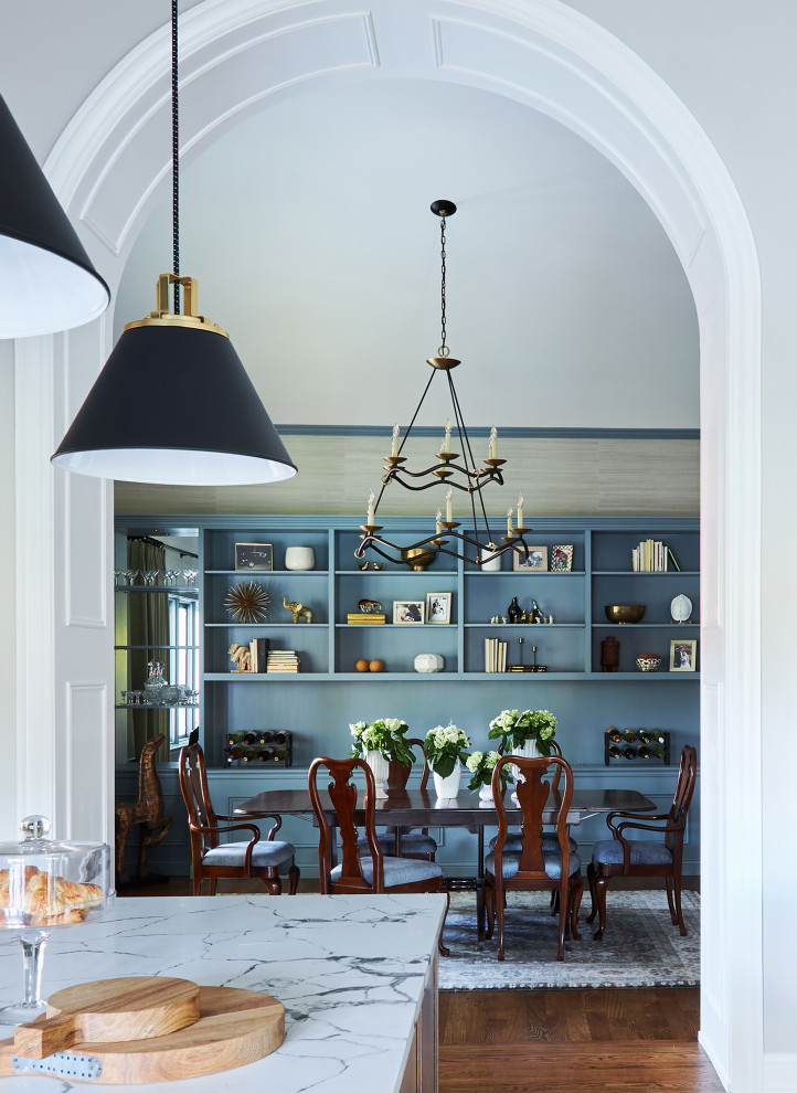 Inspiration for a large classic enclosed dining room in Chicago with dark hardwood flooring, brown floors, a vaulted ceiling, blue walls and wallpapered walls.