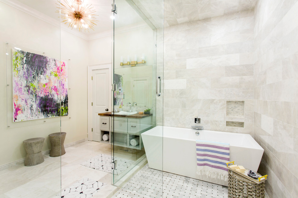 Inspiration for a transitional master bathroom in Little Rock with shaker cabinets, beige cabinets, a freestanding tub, an alcove shower, beige tile, beige walls, marble floors, a drop-in sink, wood benchtops, a hinged shower door and brown benchtops.