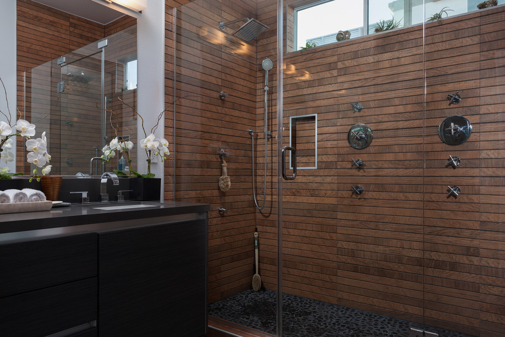 Inspiration for a mid-sized modern 3/4 bathroom in Los Angeles with light wood cabinets, a double shower, brown tile, stone tile, brown walls, light hardwood floors, an undermount sink and granite benchtops.