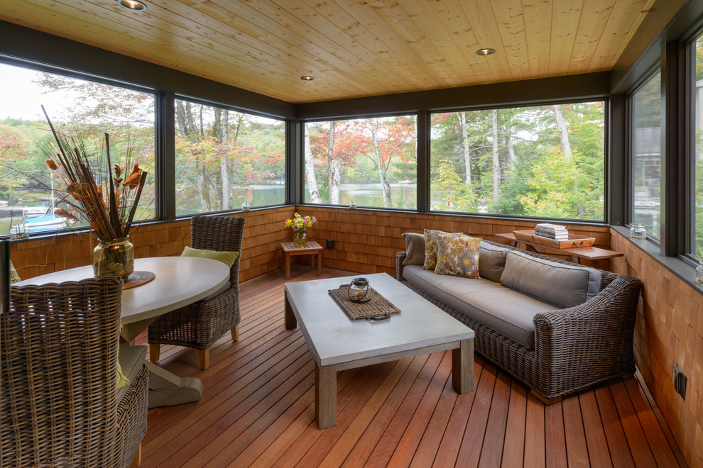 Large rustic conservatory in Boston with medium hardwood flooring, no fireplace, a standard ceiling and brown floors.