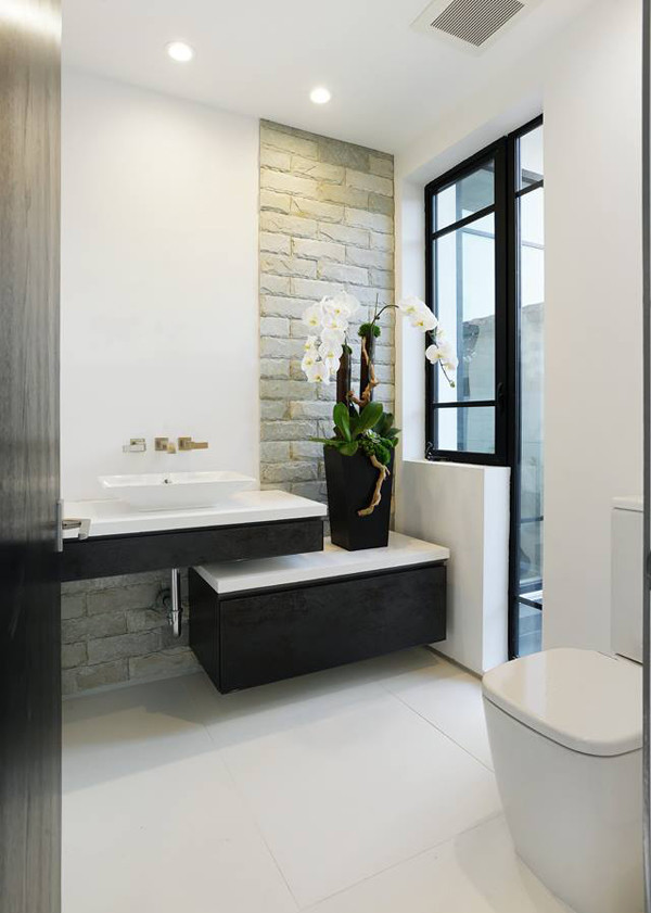 Inspiration for a large modern master bathroom in Los Angeles with flat-panel cabinets, white cabinets, a corner tub, an open shower, a one-piece toilet, white tile, stone tile, white walls, ceramic floors, a pedestal sink and soapstone benchtops.