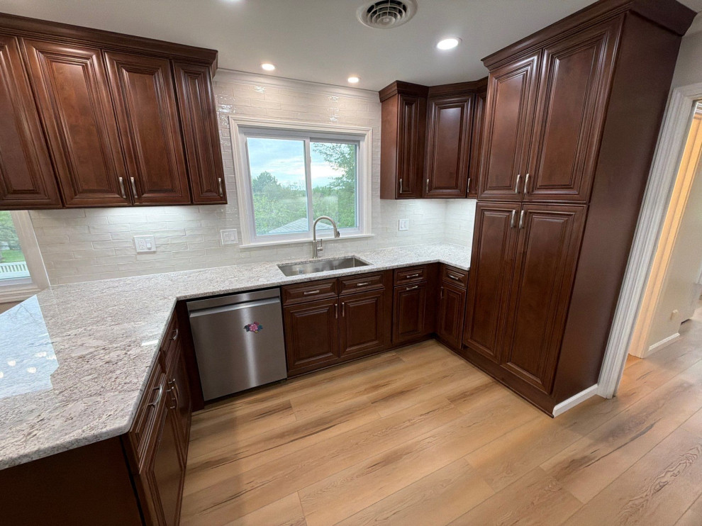 USCD cabinetry accompanied granite countertops, porcelain tile backsplash and Ca