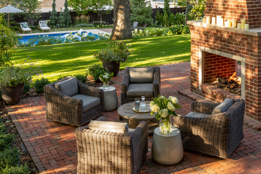 Example of a small arts and crafts backyard brick patio design in Minneapolis with a fireplace and a pergola