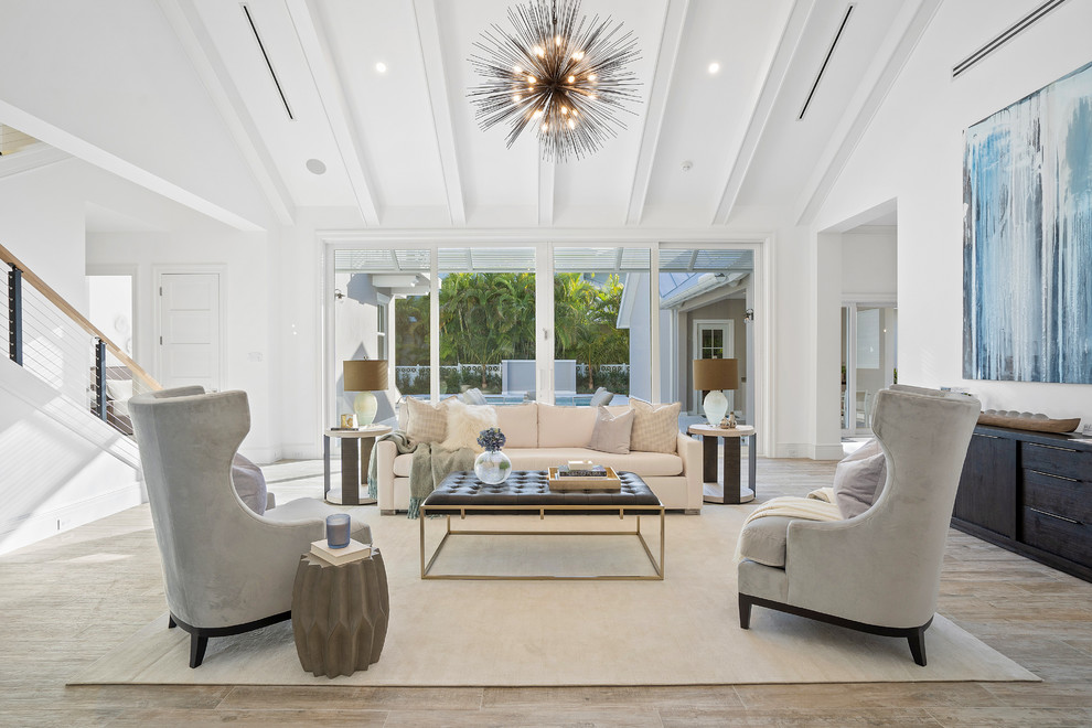 Photo of a contemporary living room in Miami with white walls, medium hardwood floors and brown floor.