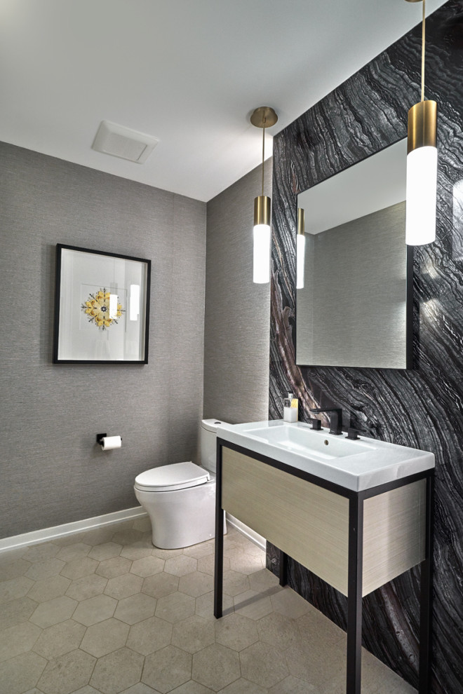 Inspiration for a medium sized modern cloakroom in Chicago with flat-panel cabinets, grey cabinets, a one-piece toilet, grey walls, porcelain flooring, a console sink, beige floors, white worktops, a freestanding vanity unit and wallpapered walls.