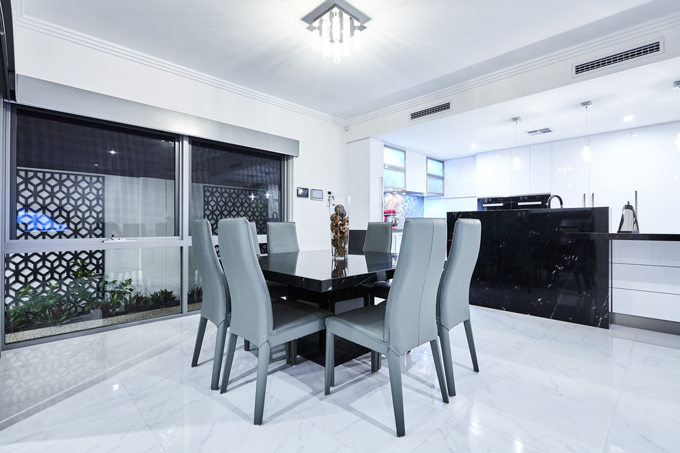 Photo of a contemporary kitchen/dining combo in Perth with white walls.