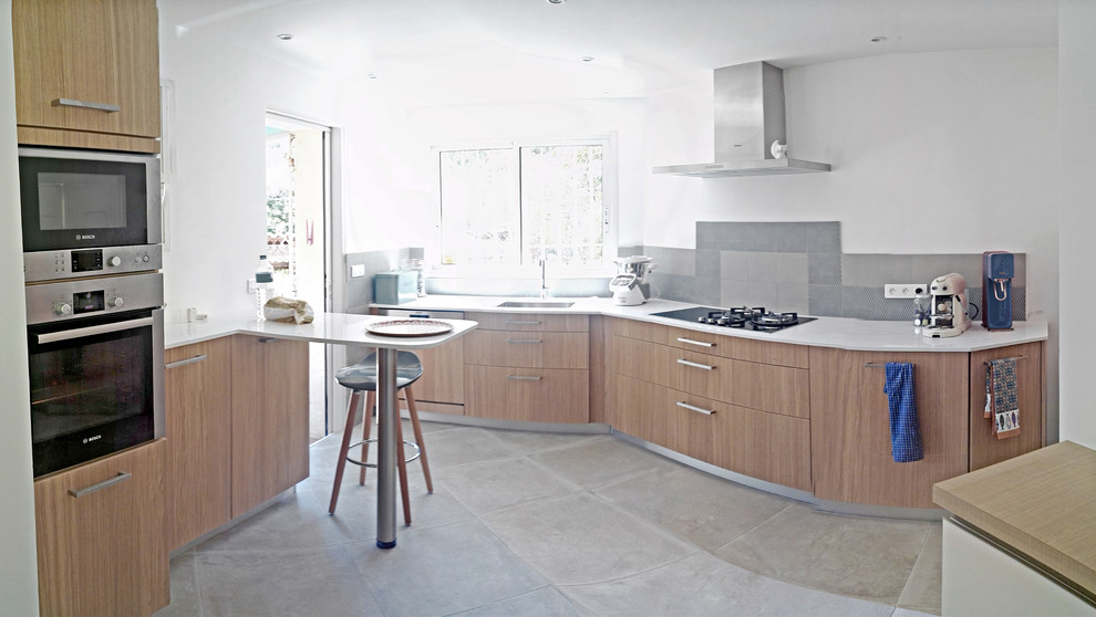 Inspiration for a large contemporary l-shaped open plan kitchen in Other with an integrated sink, flat-panel cabinets, medium wood cabinets, quartzite benchtops, grey splashback, ceramic splashback, stainless steel appliances, ceramic floors, a peninsula, grey floor and white benchtop.