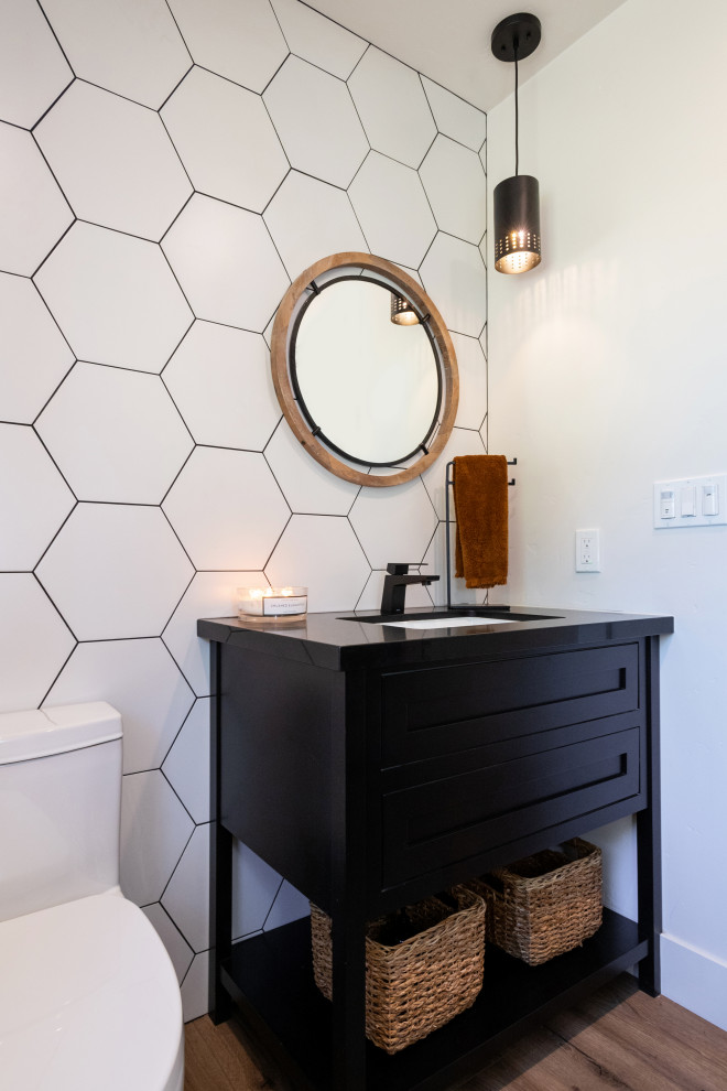 Inspiration for a large country bathroom in Sacramento with shaker cabinets, black cabinets, light hardwood floors, brown floor and vaulted.