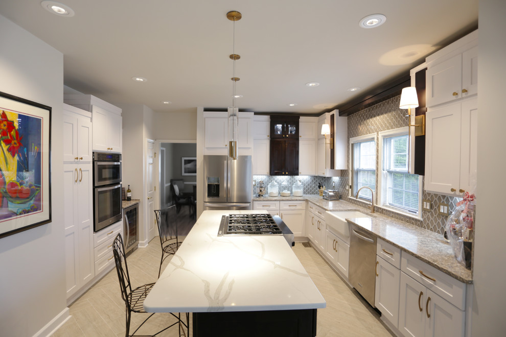 Design ideas for a mid-sized transitional u-shaped separate kitchen in DC Metro with a farmhouse sink, shaker cabinets, white cabinets, quartz benchtops, multi-coloured splashback, stainless steel appliances, porcelain floors, with island, beige floor and multi-coloured benchtop.