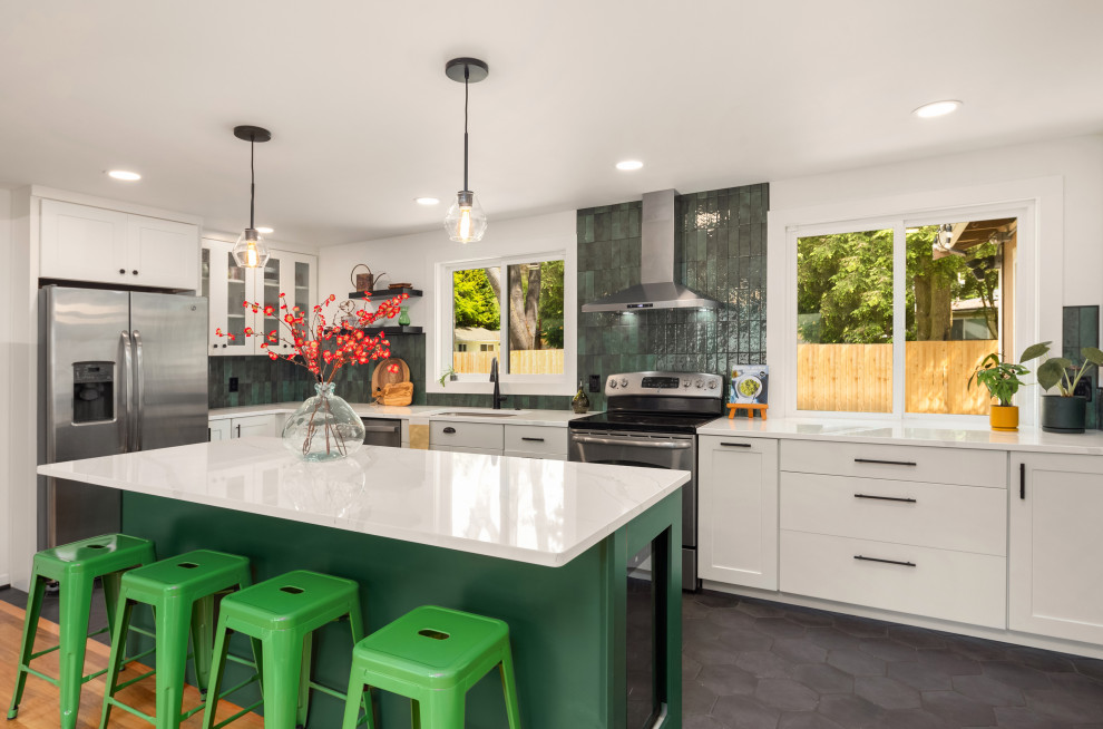 Mid-sized midcentury open plan kitchen in Seattle with an undermount sink, recessed-panel cabinets, green cabinets, quartz benchtops, green splashback, ceramic splashback, stainless steel appliances, light hardwood floors, with island, brown floor and white benchtop.