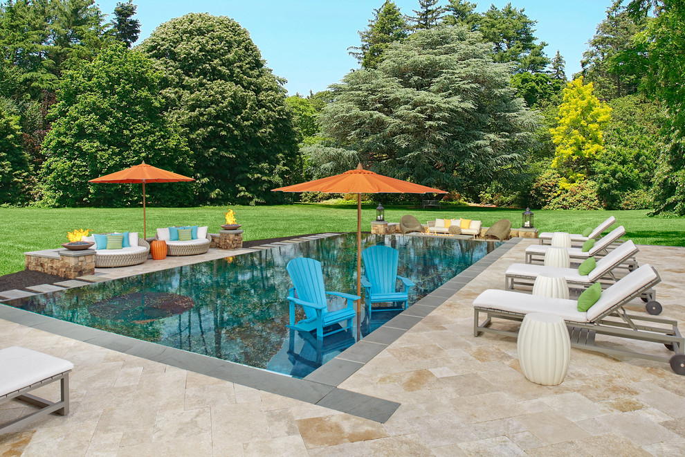 Design ideas for a large contemporary backyard rectangular infinity pool in DC Metro with natural stone pavers.