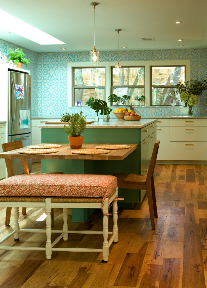Photo of an eclectic kitchen in Austin with flat-panel cabinets, blue cabinets and stainless steel appliances.