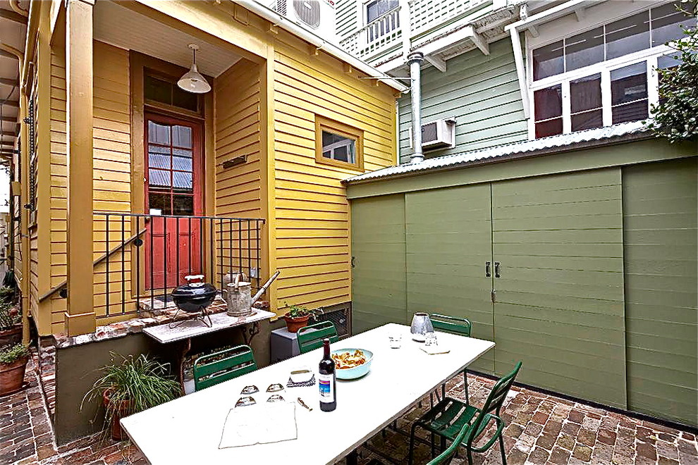 Design ideas for an eclectic courtyard patio in New Orleans with brick pavers.
