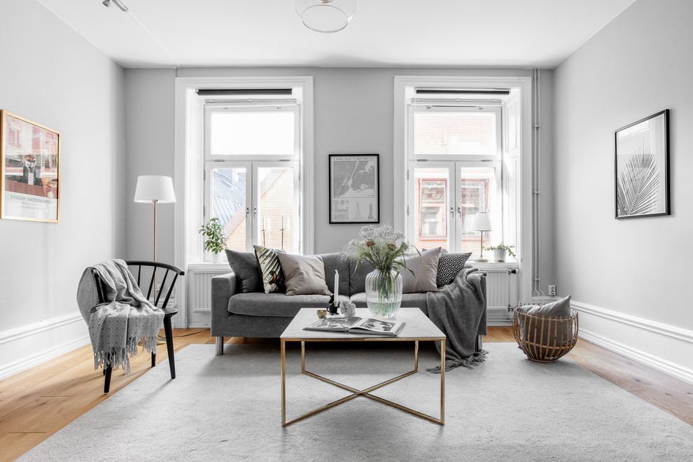Photo of a mid-sized scandinavian formal living room in Stockholm with white walls.