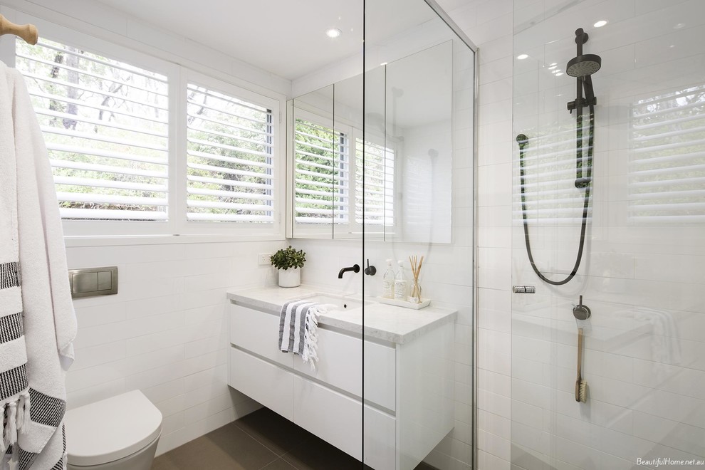 Photo of a mid-sized contemporary master bathroom in Melbourne with an undermount sink, beaded inset cabinets, white tile, subway tile and white walls.