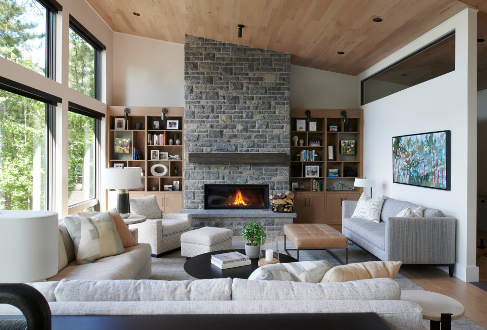Design ideas for a large contemporary open plan living room in Toronto with white walls, a wall mounted tv, medium hardwood flooring, a ribbon fireplace, a stone fireplace surround, brown floors, a vaulted ceiling and a wood ceiling.