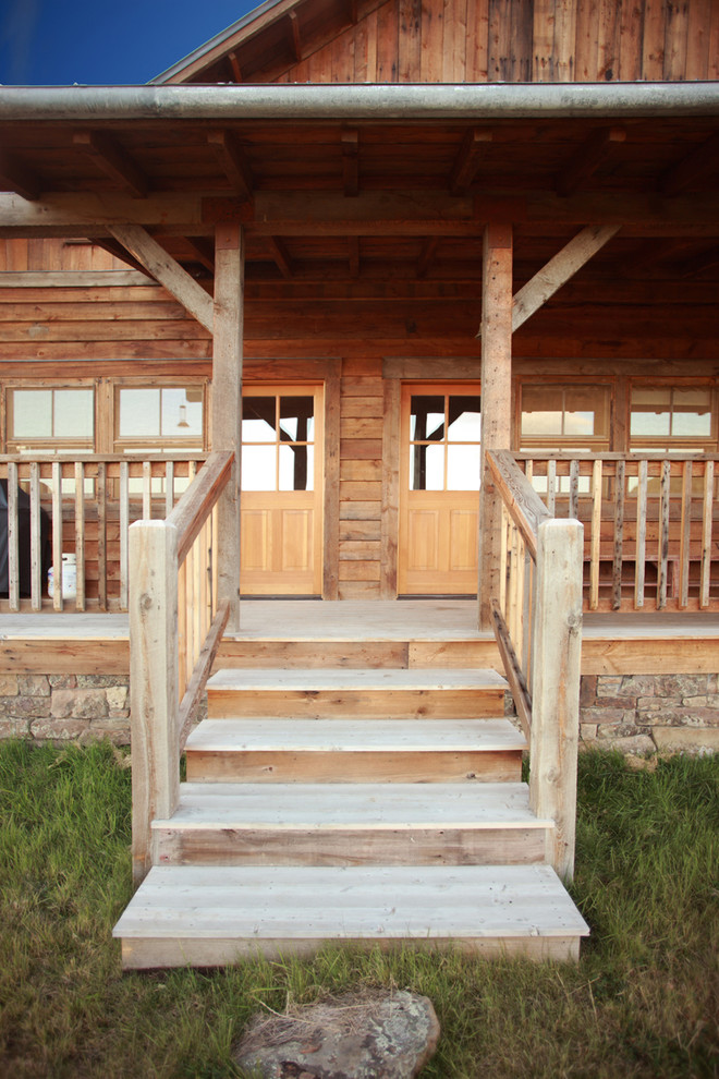 Inspiration for a rustic deck remodel with a roof extension