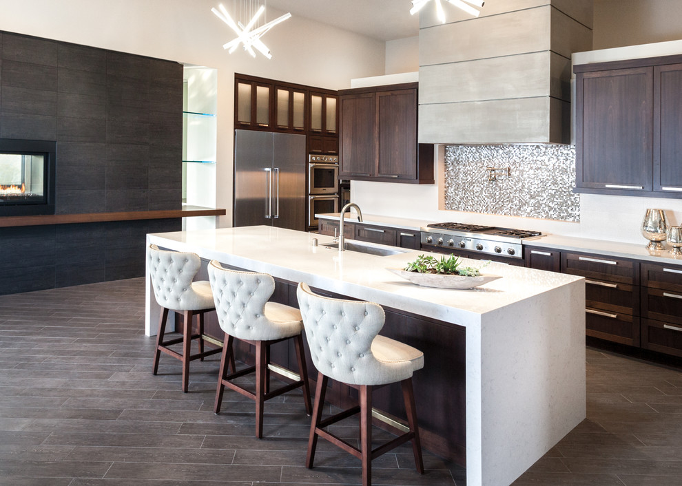 Example of a transitional kitchen design with an island