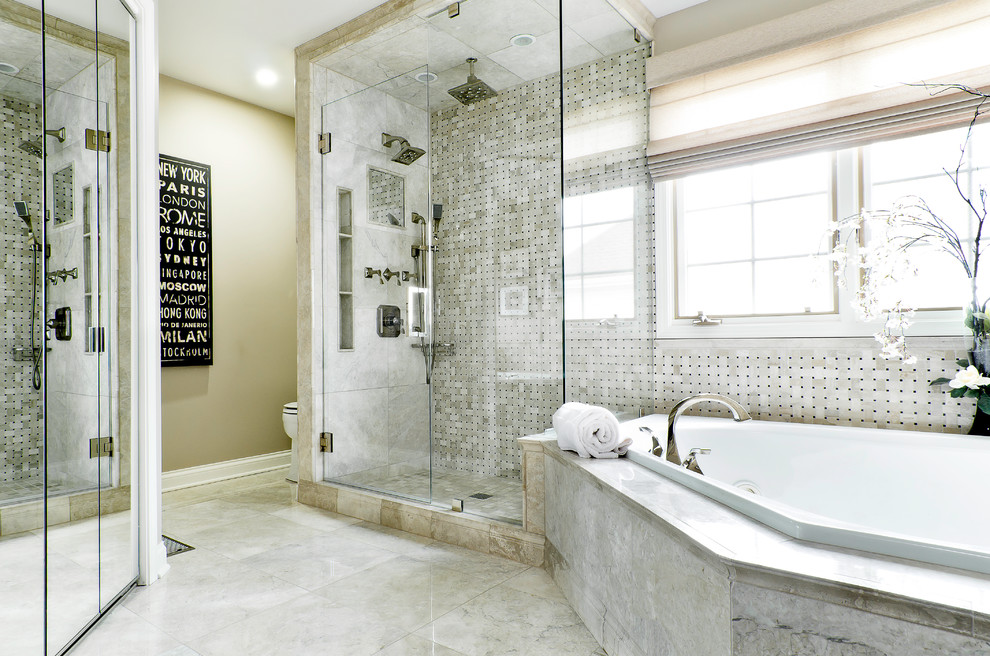 This is an example of a large contemporary master bathroom in Chicago with an alcove shower, beige tile, a drop-in tub, stone tile, grey walls and marble floors.