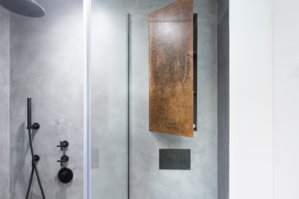 Small industrial master bathroom in London with beaded inset cabinets, brown cabinets, an open shower, a wall-mount toilet, gray tile, grey walls, concrete floors, a wall-mount sink, grey floor and a hinged shower door.