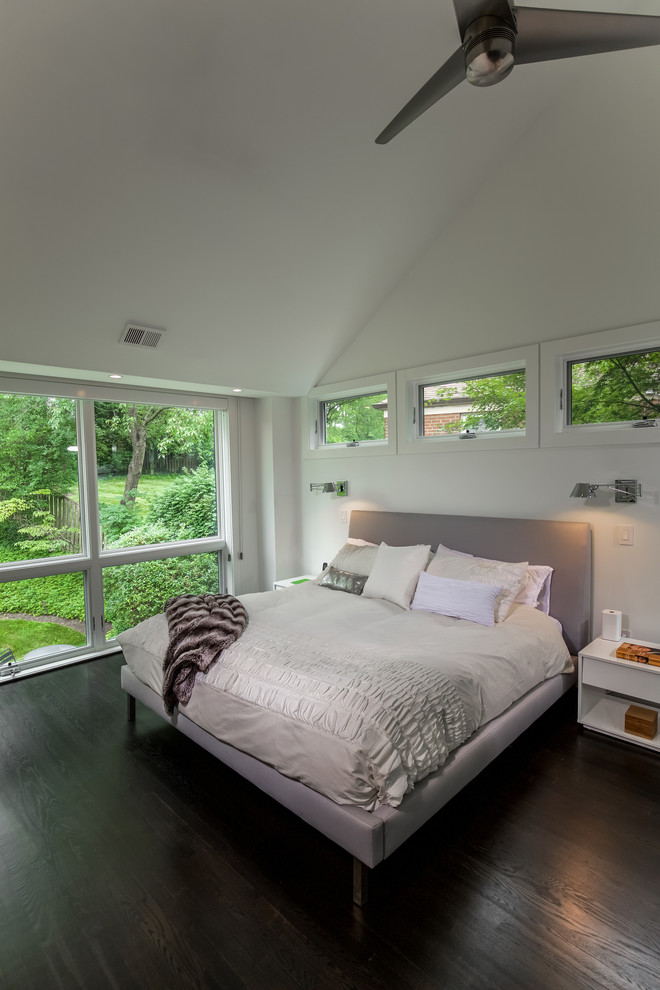 Mid-sized contemporary master bedroom in DC Metro with white walls, dark hardwood floors and no fireplace.
