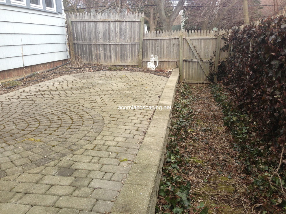 This is an example of a small traditional backyard patio in New York with concrete pavers.