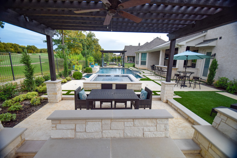 This is an example of a mid-sized contemporary backyard patio in Dallas with a water feature and natural stone pavers.