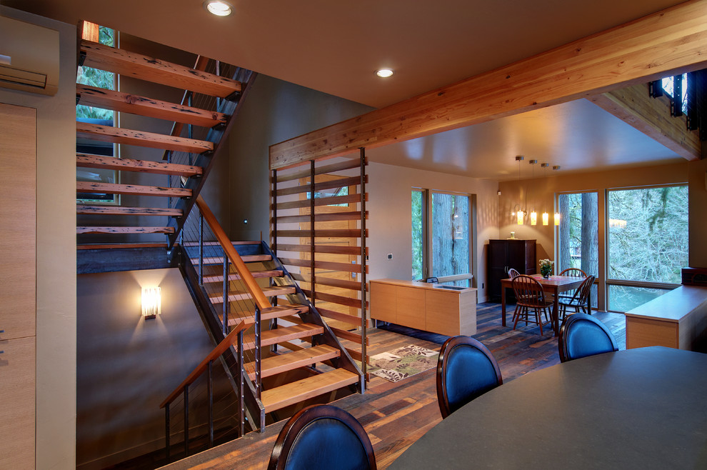 This is an example of a contemporary wood u-shaped staircase in Other with open risers.
