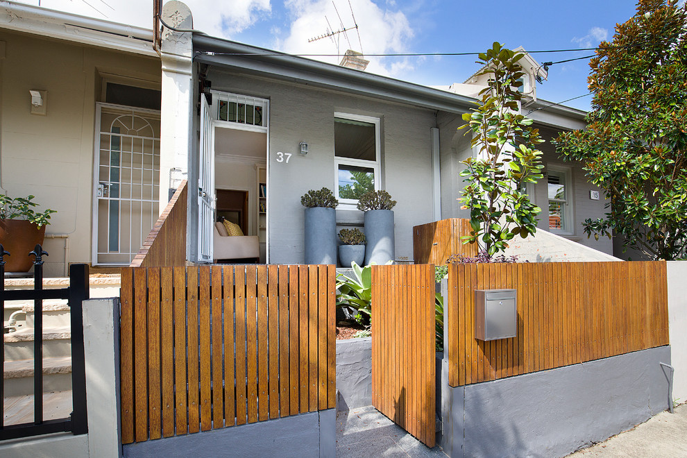 Contemporary one-storey brick grey house exterior in Sydney with a shed roof.
