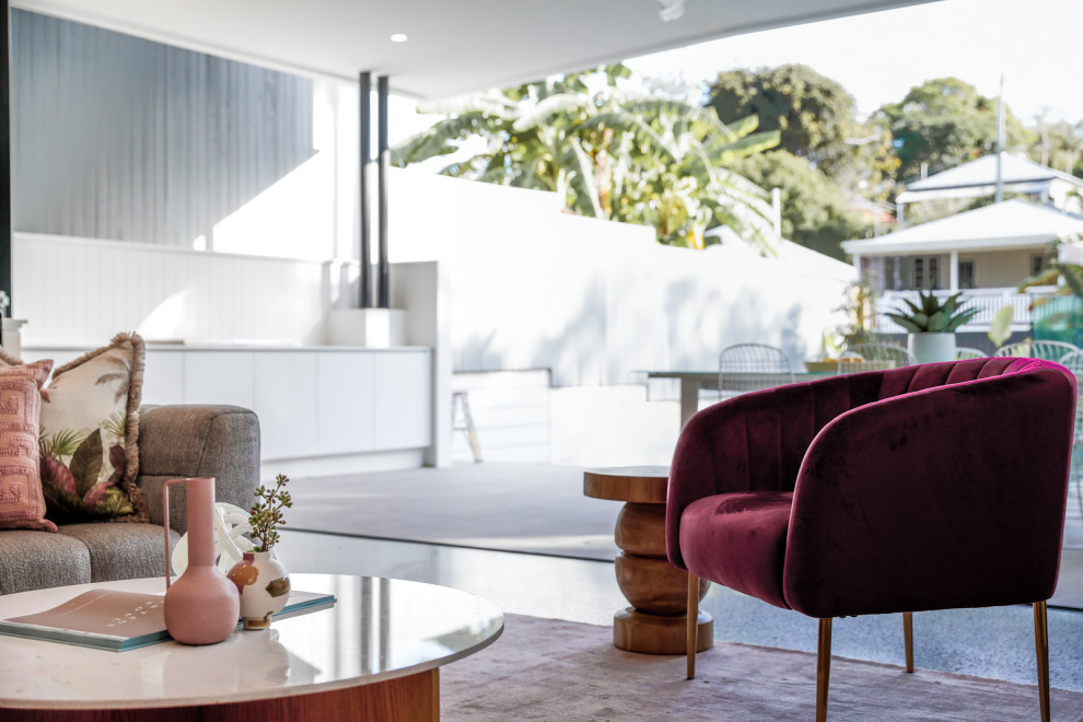 This is an example of a large contemporary open concept living room in Brisbane with concrete floors.