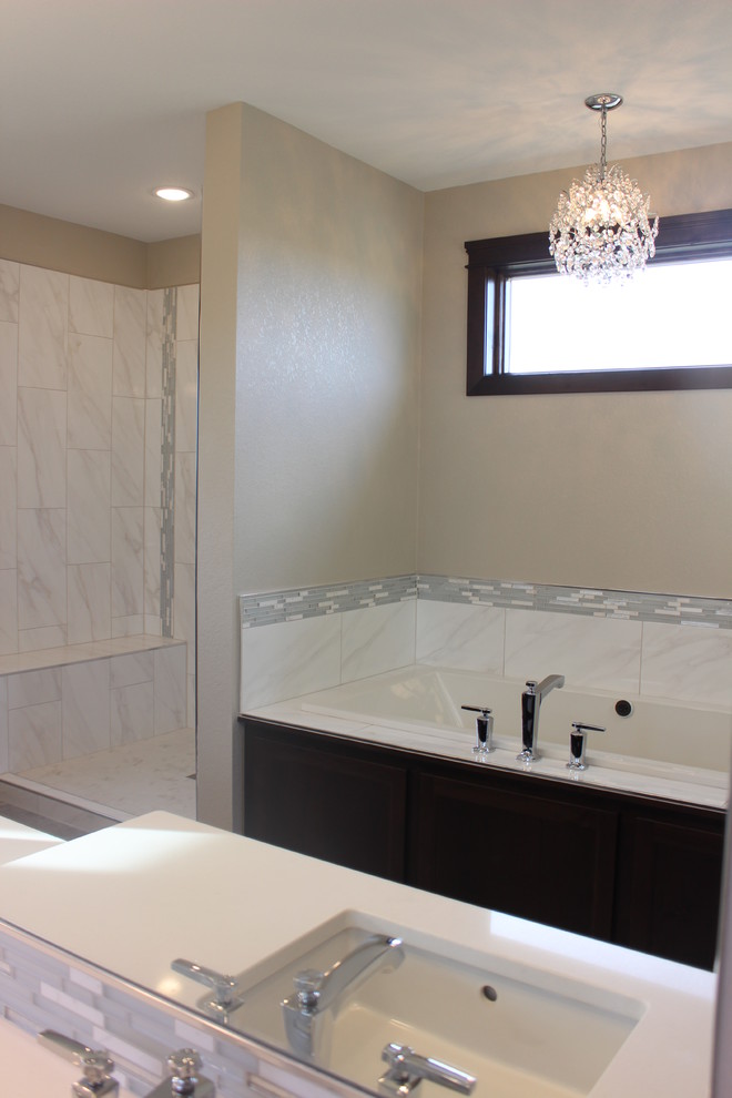 Large transitional master gray tile, white tile and matchstick tile porcelain tile bathroom photo with shaker cabinets, dark wood cabinets, beige walls, an undermount sink and quartz countertops