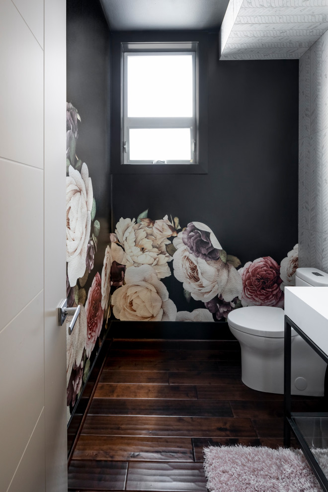 Design ideas for a small contemporary powder room in Seattle with black cabinets, a one-piece toilet, white tile, porcelain tile, black walls, dark hardwood floors, a console sink, marble benchtops, white benchtops, a freestanding vanity and wallpaper.