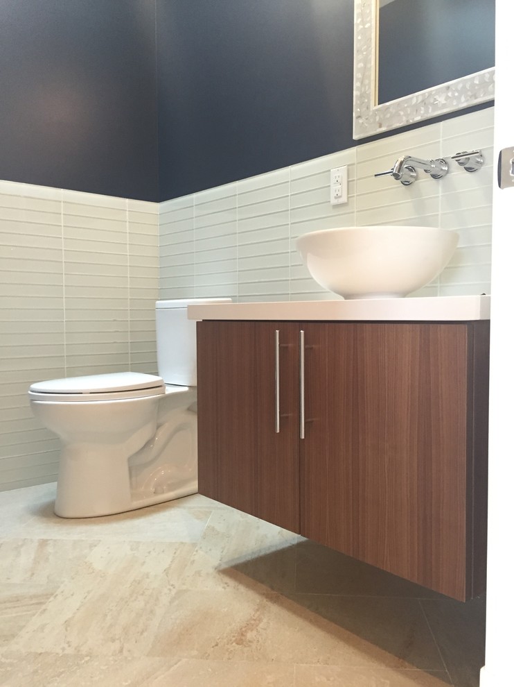 Mid-sized transitional powder room in San Francisco with flat-panel cabinets, medium wood cabinets, a one-piece toilet, beige tile, glass tile, blue walls, a vessel sink and engineered quartz benchtops.