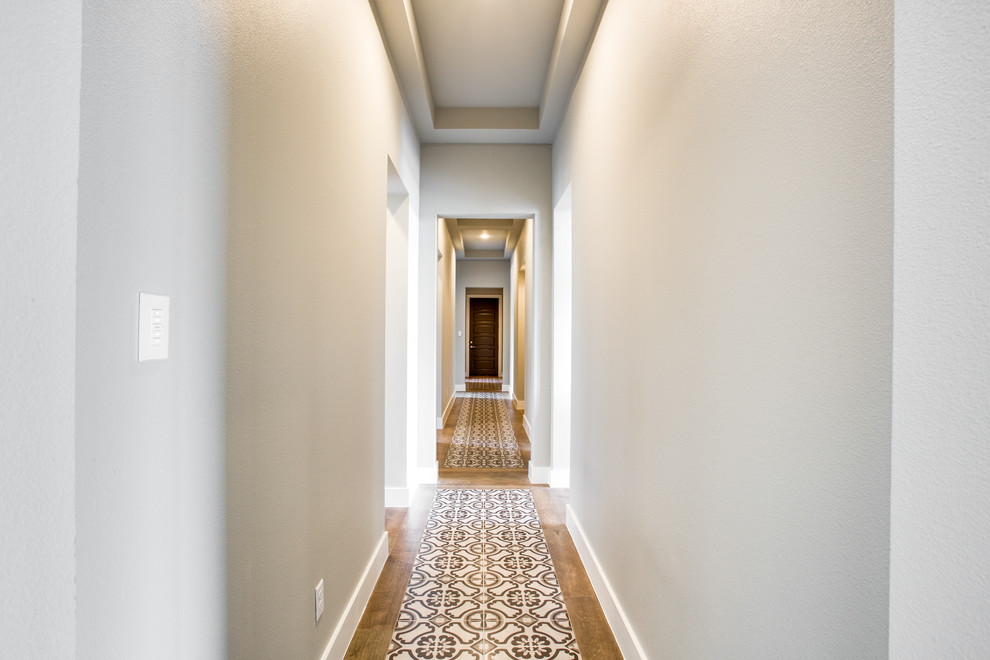 Design ideas for a small transitional hallway in Austin with grey walls and multi-coloured floor.