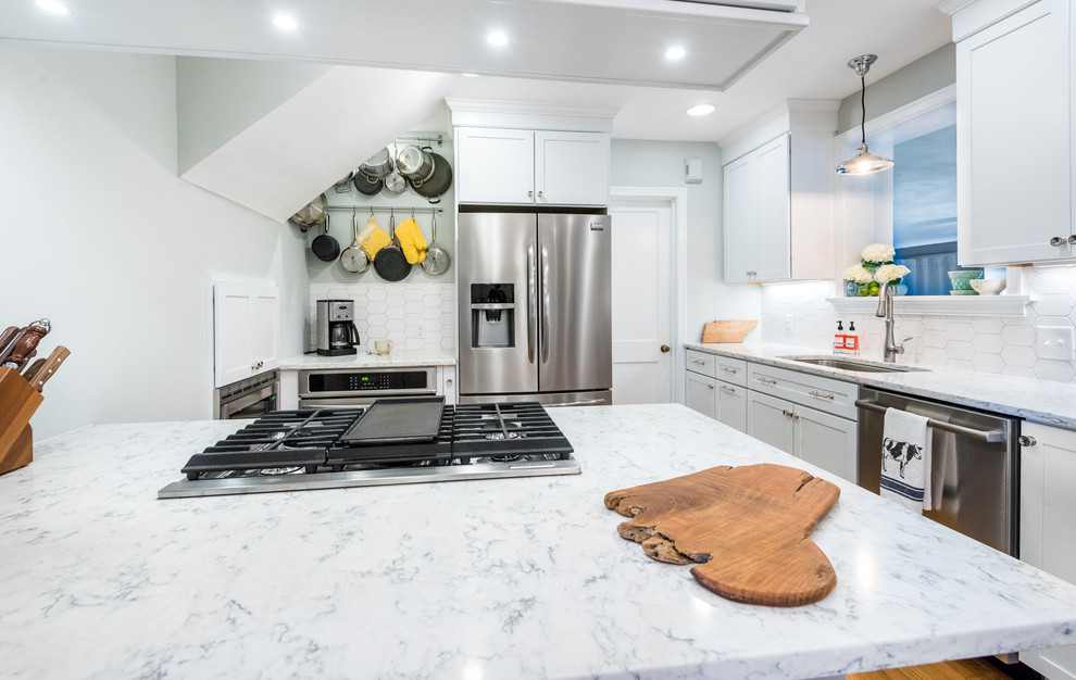 Transitional medium tone wood floor kitchen photo in Richmond with a single-bowl sink, shaker cabinets, white cabinets, quartzite countertops, stainless steel appliances, a peninsula, white backsplash and mosaic tile backsplash