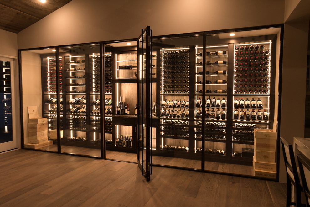 Inspiration for a large contemporary medium tone wood floor wine cellar remodel in Orange County