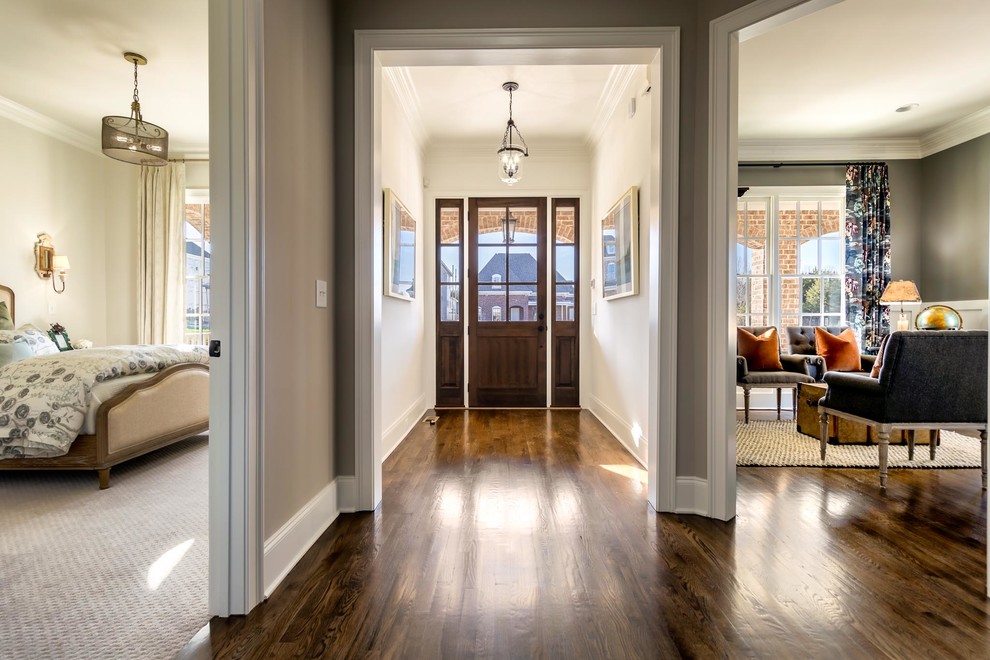 Photo of a large transitional front door in Nashville with beige walls, dark hardwood floors, a single front door and a dark wood front door.