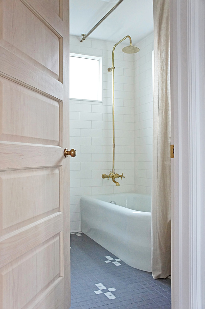 Inspiration for a mid-sized transitional bathroom in Portland with a corner tub, a shower/bathtub combo, a two-piece toilet, white tile, subway tile, white walls, terrazzo floors, grey floor and a shower curtain.