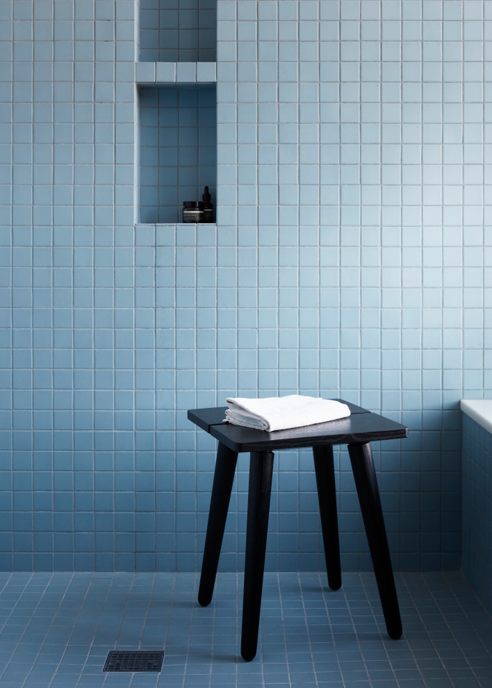 Design ideas for a large modern master wet room bathroom in New York with blue tile, ceramic tile, blue walls, ceramic floors, blue floor, a hinged shower door and a shower seat.