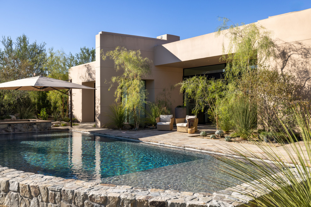 Inspiration for a huge southwestern backyard stone and rectangular natural hot tub remodel in Seattle