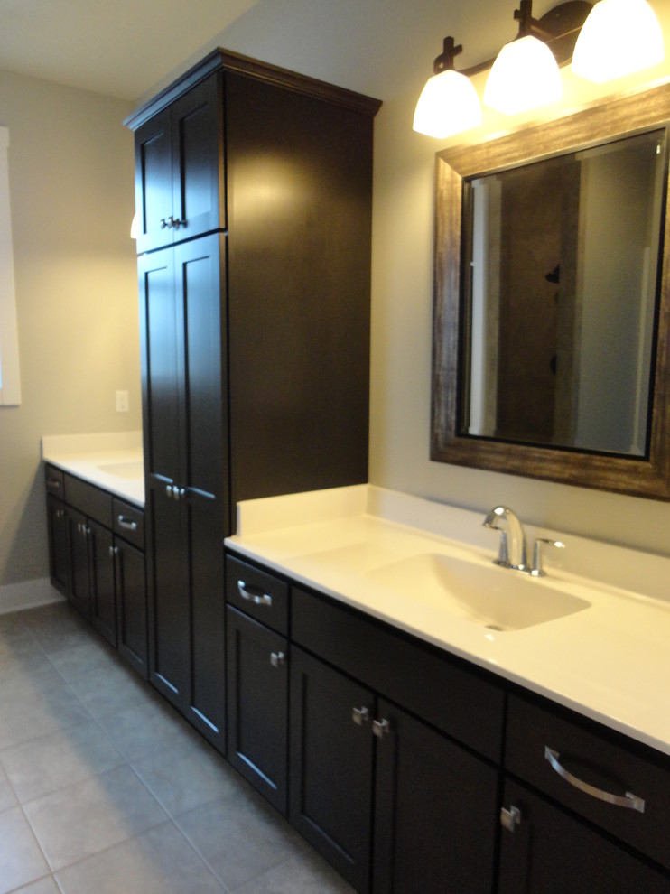 Design ideas for a mid-sized traditional master bathroom in Milwaukee with an integrated sink, recessed-panel cabinets, dark wood cabinets, engineered quartz benchtops, an open shower, a two-piece toilet, gray tile, ceramic tile, grey walls and ceramic floors.