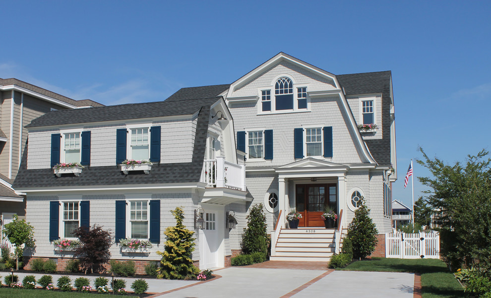 Example of a beach style exterior home design in Philadelphia with a gambrel roof