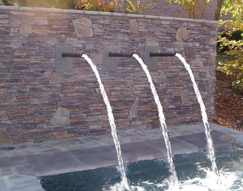 Pool fountain - mid-sized contemporary backyard stone natural pool fountain idea