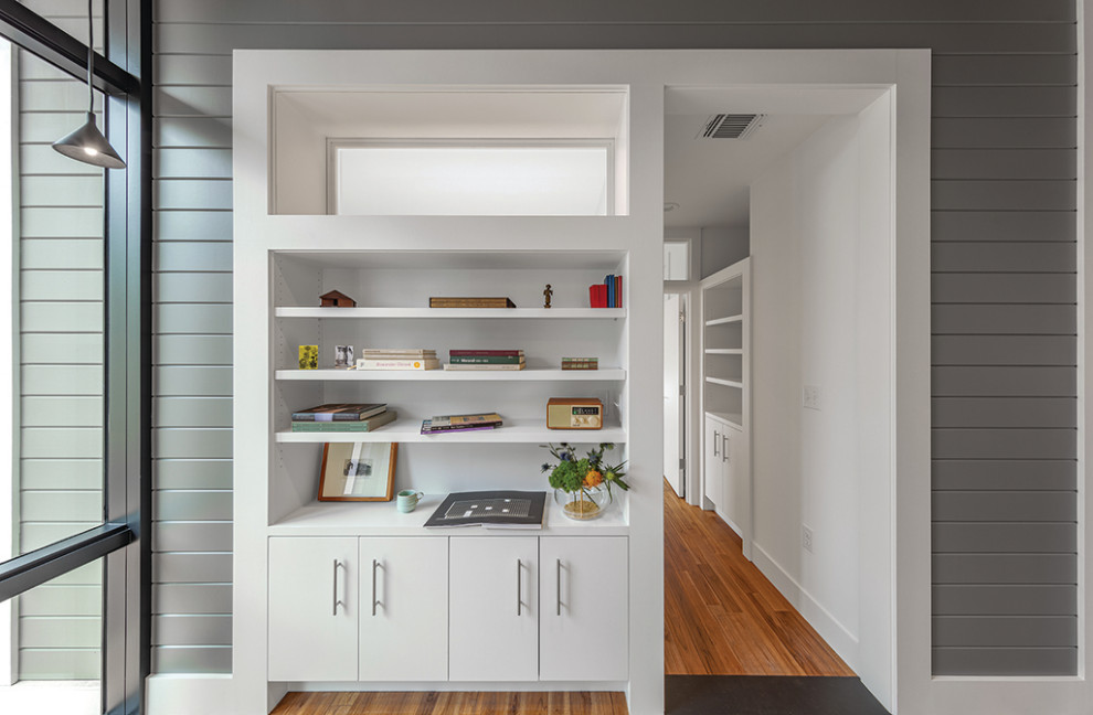 Design ideas for a mid-sized modern vestibule in Austin with grey walls, medium hardwood floors, brown floor, wood and planked wall panelling.