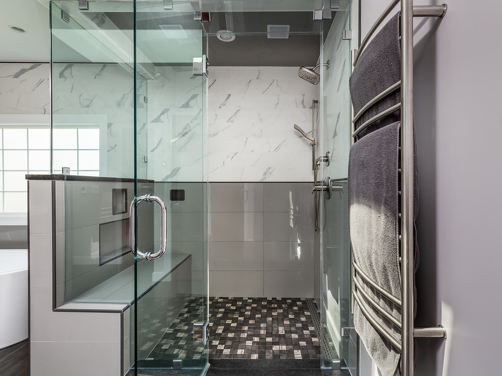 Large modern master bathroom in DC Metro with furniture-like cabinets, brown cabinets, a freestanding tub, a corner shower, a two-piece toilet, white tile, porcelain tile, white walls, porcelain floors, a vessel sink, quartzite benchtops, multi-coloured floor, a hinged shower door and black benchtops.
