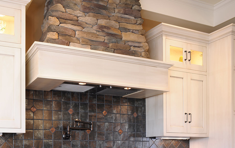 Transitional enclosed kitchen photo in St Louis with shaker cabinets, white cabinets, brown backsplash, ceramic backsplash and stainless steel appliances