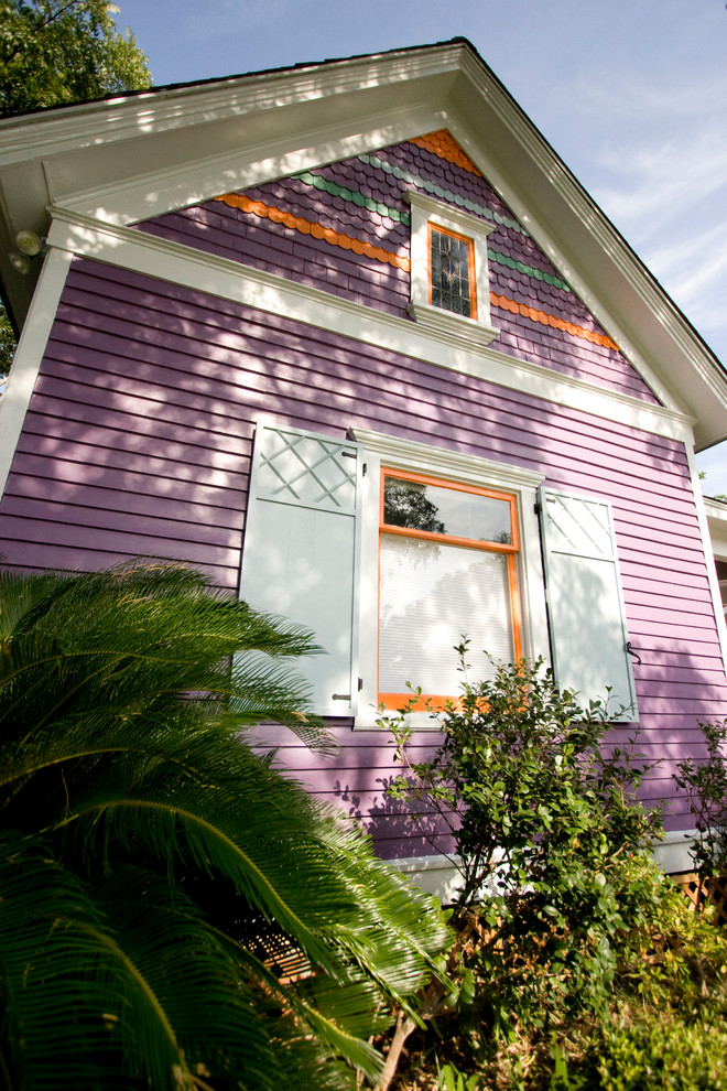 This is an example of a mid-sized traditional one-storey multi-coloured exterior in Houston with wood siding and a gable roof.